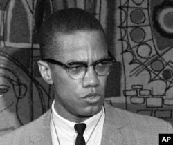 FILE - Malcolm X addresses reporters at what was then known as the Park Sheraton Hotel in New York, March 12, 1964.