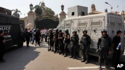 FILE - Egyptian security forces stand guard at Cairo University, Oct. 12, 2014. 