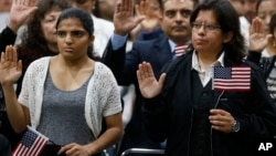 FILE - Immigrants take the citizenship oath during naturalization ceremonies at a U.S. Citizenship and Immigration Services ceremony in Los Angeles, California, Sept. 20, 2017.