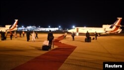 FILE - Employees arrange the red carpet at the airport in Abuja, Nigeria May 14, 2016. 