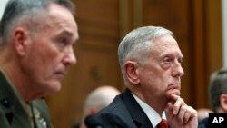 Joint Chiefs Chairman Gen. Joseph Dunford (left) and Defense Secretary Jim Mattis listen to a question as they testify at a House Armed Services Committee hearing on the defense budget.