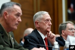 Joint Chiefs Chairman Gen. Joseph Dunford, left, Defense Secretary Jim Mattis, and Defense Under Secretary and Chief Financial Office David Norquist, listen to a question as they testify at a House Armed Services Committee hearing on the FY'18 defense bud