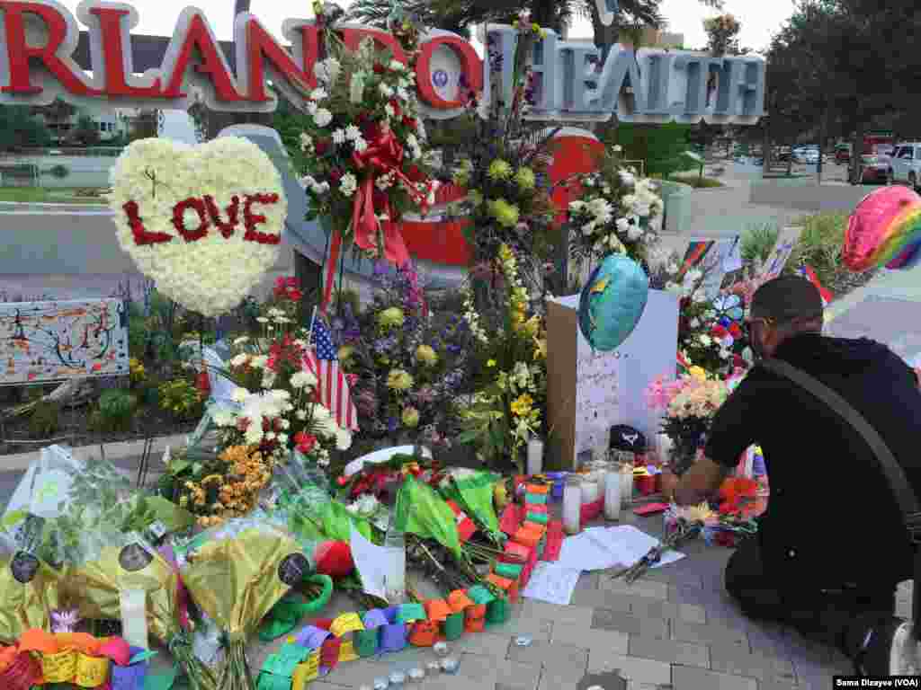 People leave flowers and other items at a makeshift vigil outside the Orlando Regional Medical Center, which is close to where the mass shooting occurred at the Pulse gay nightclub early Sunday in Orlando, Florida, June 14, 2016.