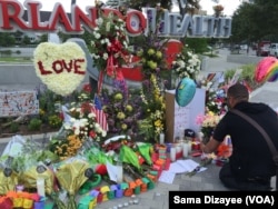 FILE - People leave flowers and other items at a makeshift vigil outside the Orlando Regional Medical Center, which is close to where the mass shooting occurred at the Pulse gay nightclub in Orlando, Florida, June 14, 2016.