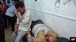 Wounded men are seen in the Sunni Muslim district of Baba Amr in Homs, Syria, February 8, 2012.