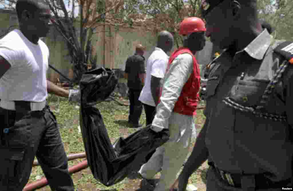 Rescue personnel recover mangled bodies wrapped in black polythene at the site of a bomb blast at This Day newspaper premises in Abuja April 26, 2012.