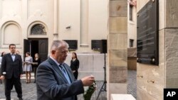  Szabolcs Szit, Director of the Holocaust Memorial Center, lays a wreath at a memorial plaque dedicated to Emil Wiesmeyer, who helped to save the lives of thousands of Jewish Hungarians during WWII. Swedish Ambassador to Hungary Niclas Touve, left, looks on during an unveiling ceremony at HMC in Budapest, Hungary, Oct. 18, 2017. 