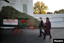 First Lady Melania Trump and her son Barron Trump welcome the official White House Christmas Tree, a Wisconsin-grown tree provided by the Chapman family of Silent Night Evergreens, to the White House in Washington, Nov. 20, 2017.