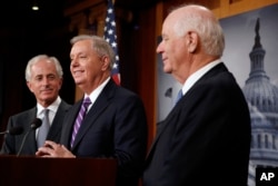 Sen. Bob Corker, R-Tenn., from left, Sen. Lindsey Graham, R-S.C., and Sen. Ben Cardin, D-Md., attend a news conference about efforts to end modern slavery, Sept. 14, 2017, on Capitol Hill in Washington.