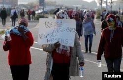 Migrant women demonstrate on the second day of their evacuation and transfer to reception centers in France, as part of the dismantlement of the camp called "the jungle" in Calais, France, Oct. 25, 2016.
