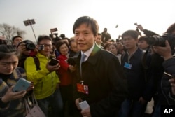 FILE -- Lei Jun, billionaire CEO and founder of Chinese electronics firm Xiaomi, arrives at the Great Hall of the People before the opening session of the National People's Congress (NPC) in Beijing.