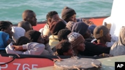 Migrants picked up by a Coast Guard boat arrive at the Sicilian Porto Empedocle harbor, Italy, April 13, 2015.