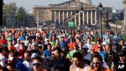 Runners make their way down the Champs Elysees avenue at the start of the 41st Paris Marathon in Paris, Sunday, April 9, 2017. (AP Photo/Thibault Camus)