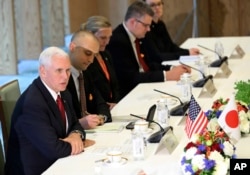 U.S. Vice President Mike Pence, left, speaks with Japanese Deputy Prime Minister and Finance Minister Taro Aso, not in picture, during the Japan-U.S. Economic Dialogue at the prime minister's office in Tokyo, April 18, 2017.