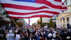 美国前副总统拜登的支持者挥舞美国国旗庆祝胜利。（2020年11月7日）