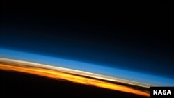 FILE - This image of sunset on the Indian Ocean was taken by astronauts aboard the International Space Station (ISS). The image presents an edge-on, or limb view, of the Earth’s atmosphere as seen from orbit.