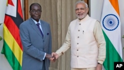 Zimbabwe's President Robert Mugabe, left, poses with Indian Prime Minister Narendra Modi, before a bilateral meeting on the sidelines of the India Africa Forum Summit, in New Delhi, India, Wednesday, Oct. 28, 2015. (AP Photo/ Manish Swarup)