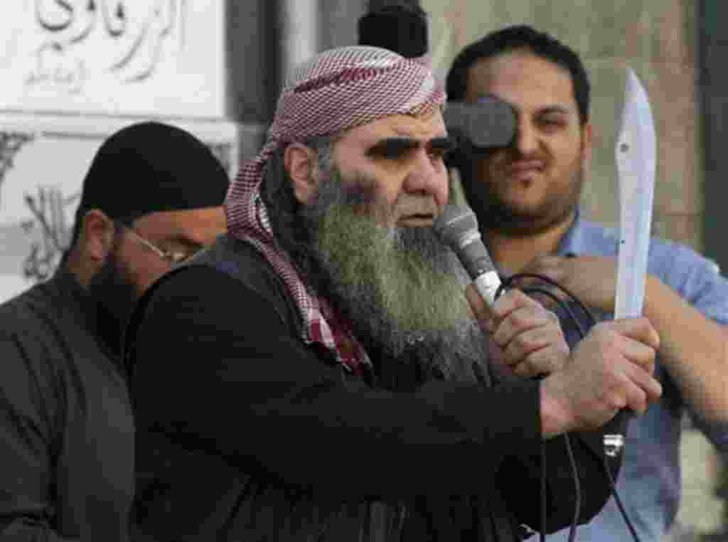 A Salafi protester holds a sword during a demonstration for extremist Salafi Muslims in the town of Zarqa, east of Amman, Jordan, Friday, April 15, 2011. The Islamic hard-liners clashed with supporters of Jordan's king, wounding dozens, in the latest move