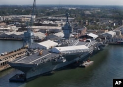 FILE - The USS Gerald R. Ford is seen at Newport News Shipbuilding in Newport News, Virginia, April 27, 2016. The $13 billion warship, the first of the Navy’s next generation of aircraft carriers, is in the final stages of construction after delays and cost overruns.