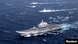 FILE - China's Liaoning aircraft carrier with accompanying fleet conducts a drill in an area of South China Sea, in this photo taken December 2016.
