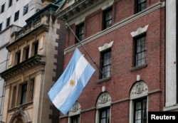 The flag hangs at half staff at the Argentine Consulate in Manhattan, recognizing the five Argentine citizens killed Tuesday in a terrorist attack in New York.