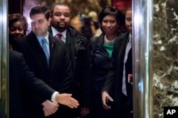 Washington Mayor Muriel Bowser, right, boards an elevator at Trump Tower in New York, Dec. 6, 2016.