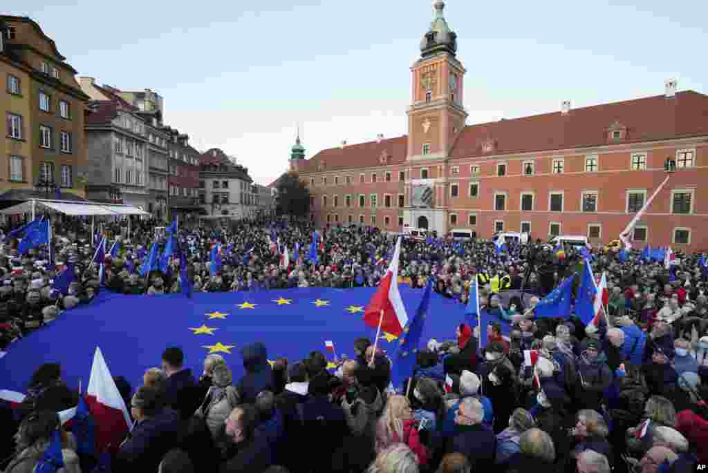 People wave EU and Polish flags in support of Poland&#39;s EU membership during a demonstration, in Warsaw, Poland.