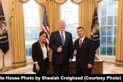 President Donald Trump welcomes State of the Union honored guests Supervisory Special Agent C.J. Martinez, right, of the U.S. Immigration and Customs Enforcement’s Homeland Security Investigations unit, to the Oval Office at the White House, in Washington, Jan. 30, 2018.