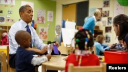 U.S. President Barack Obama reads a card during a game with children in a classroom at College Heights early childhood learning center in Decatur, Georgia, Feb. 14, 2013. The U.S. Senate on Thursday voted to repeal an Obama-era regulation that governs teacher training.