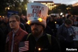 Protesters rally to demand the U.S. government protect the investigation led by Special Counsel Robert Mueller into alleged Russian meddling in the 2016 U.S. presidential election, outside the White House in Washington, Nov. 8, 2018.