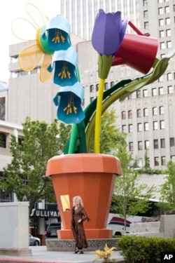Artist Ginny Ruffner stands in front of her 28-foot [8.5 meter] aluminum-and-steel flowerpot. Seattle, Washington, 2011.