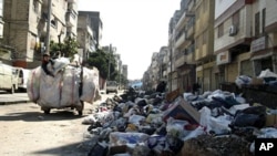 ຊາກສະຫຼັກຫັກພັງຕາມຖະນົນຫົນທາງຄຸ້ມ al-Kalidya ເມືອງ Homs