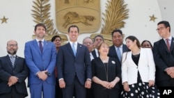 U.N. High Commissioner for Human Rights Michelle Bachelet, center right, poses for a photo with Venezuela's self proclaimed President Juan Guaido, center left, and other opposition lawmakers, on the steps of the national assembly in Caracas, Venezuela, Fr