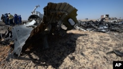 In this Russian Emergency Situations Ministry photo, Russian Emergency Ministry experts work at the crash site of a Russian passenger plane bound for St. Petersburg in Russia that crashed Saturday in Hassana, Egypt's Sinai Peninsula, Nov. 2, 2015.