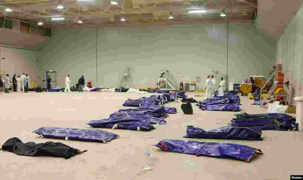 Body bags containing African migrants, who drowned trying to reach Italian shores, lie in a hangar of the Lampedusa airport, Italy, Oct. 3, 2013. 