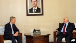 Syrian foreign minister Walid al-Moallem, right, meets with the head of the U.N. refugee agency UNHCR, Filippo Grandi in Damascus, Syria, Jan. 30, 2017.