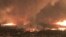 This July 26, 2018, image from video released by Cal Fire shows a fire tornado over Lake Keswick Estates near Redding, Calif. In the history of California wildfires there has never been anything like it: A churning tornado filled with fire, the size of th