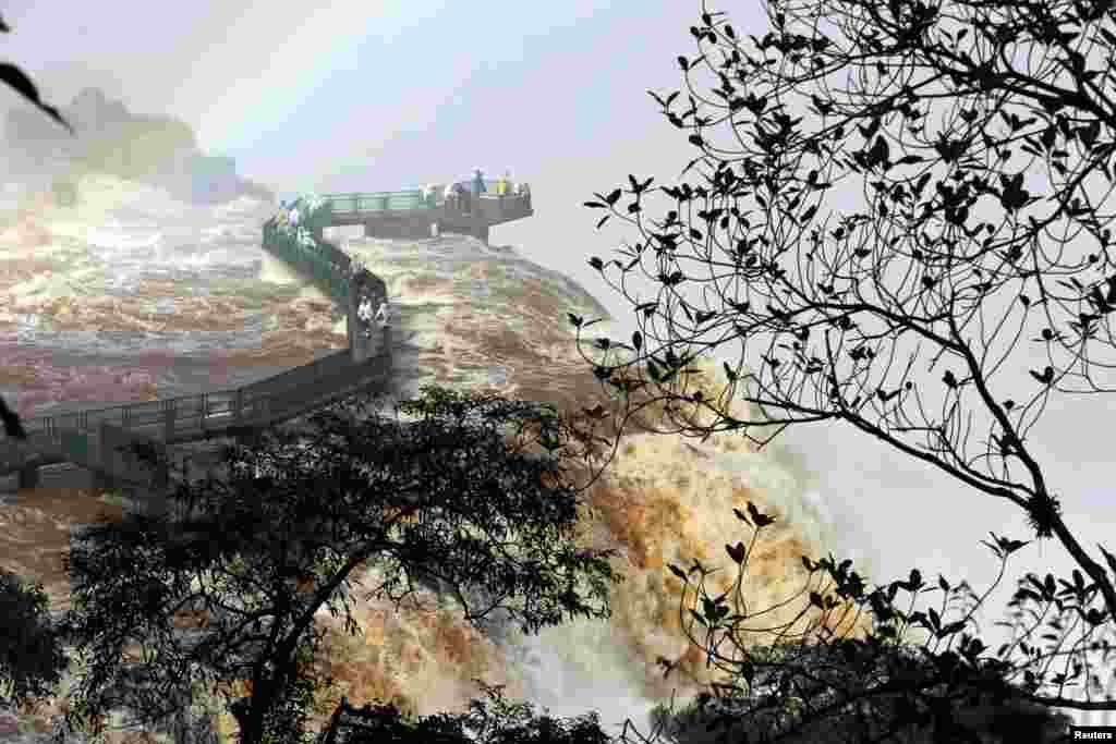 Tourists view the Iguazu Falls from an observation platform at the Iguazu National Park near the southern Brazilian city of Foz do Iguacu.