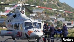 FILE - An injured South African Navy sailor is loaded into an air ambulance following an incident with a South Africa Navy submarine during exercises off Kommetjie in Cape Town, South Africa September 20, 2023.