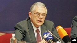 Greek Prime Minister Lucas Papademos holds a news conference after a European Union summit in Brussels, January 31, 2012.