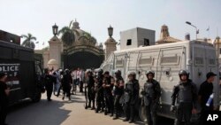 FILE - Egyptian security forces stand guard at Cairo University, Oct. 12, 2014. 