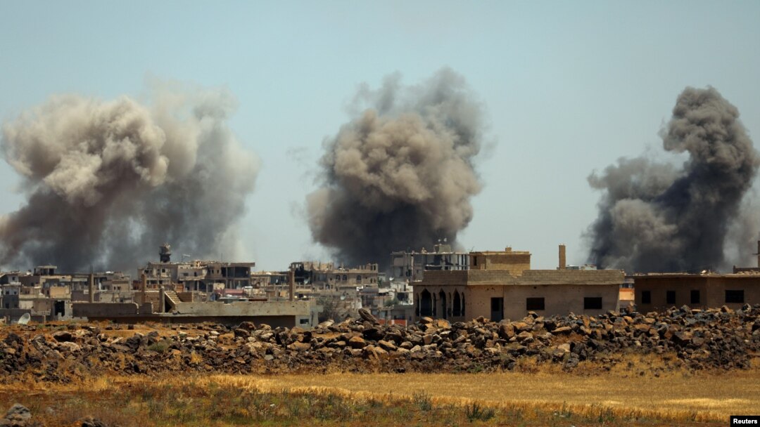 FILE - Smoke rises from al-Harak town, as seen from Deraa countryside, Syria, June 25, 2018. 