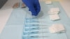 FILE - A nurse picks a syringe containing a dose of the AstraZeneca's COVID-19 vaccine at a vaccination center in Barcelona, Apr. 26, 2021. 