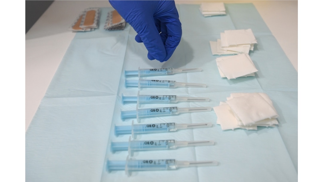 FILE - A nurse picks a syringe containing a dose of AstraZeneca's COVID-19 vaccine at a vaccination center in Barcelona, Apr. 26, 2021.