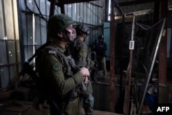 FILE - This picture taken during a media tour organised by the Israeli military on January 8, 2024, shows Israeli army Rear-Admiral and spokesperson Daniel Hagari standing in a facility that the army claims is a Hamas rocket factory in al-Bureij, in the central Gaza Strip.