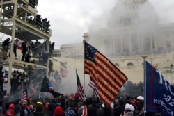 FILE - Supporters of then-President Donald Trump riot in front of the U.S. Capitol in Washington, Jan. 6, 2021, before storming the building.