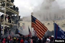 FILE - Supporters of U.S. President Donald Trump riot in front of the U.S. Capitol in Washington, Jan. 6, 2021.