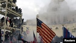 FILE - Supporters of then-President Donald Trump riot in front of the U.S. Capitol in Washington, Jan. 6, 2021. 