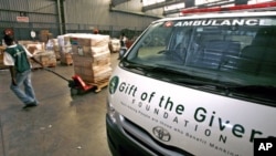 A worker pulls a trolley containing supplies to be donated to the people in need by Gift of the Givers, a South African humanitarian aid organization, at a warehouse in Johannesburg, South Africa, January 21, 2009 (file photo)