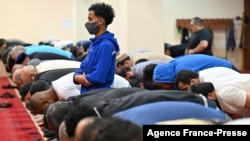 Men pray in a Muslim prayer hall at the Islamic Cultural Center in Kyiv on September 15, 2021.